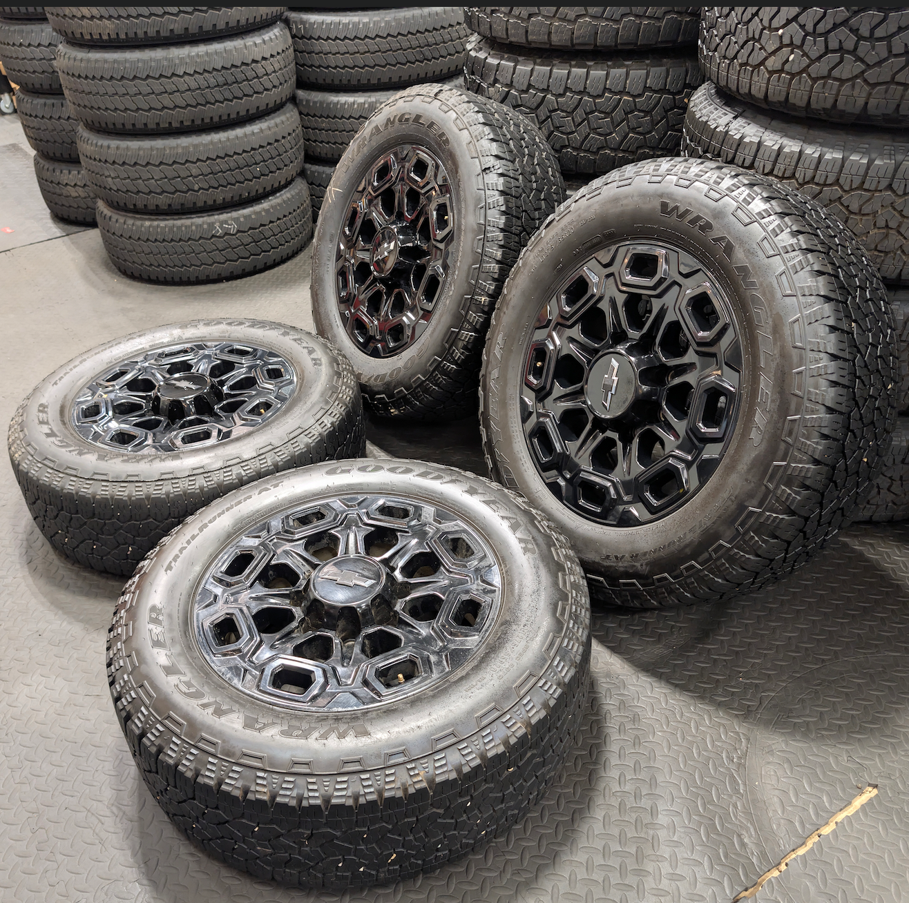 OEM 20” Gloss Black Chevrolet Silverado / GMC Sierra 2500HD & 3500HD Wheels wrapped in LT275/65R20 Goodyear Wrangler TrailRunner A/T tires.