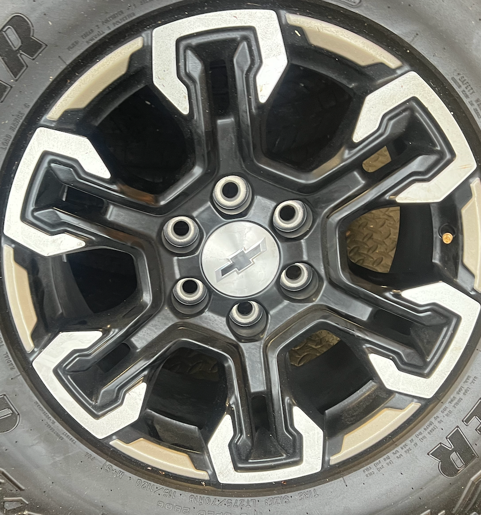 OEM 18” Gloss Black Machined Face Chevrolet Wheels wrapped in Goodyear Wrangler Territory M/T tires.
