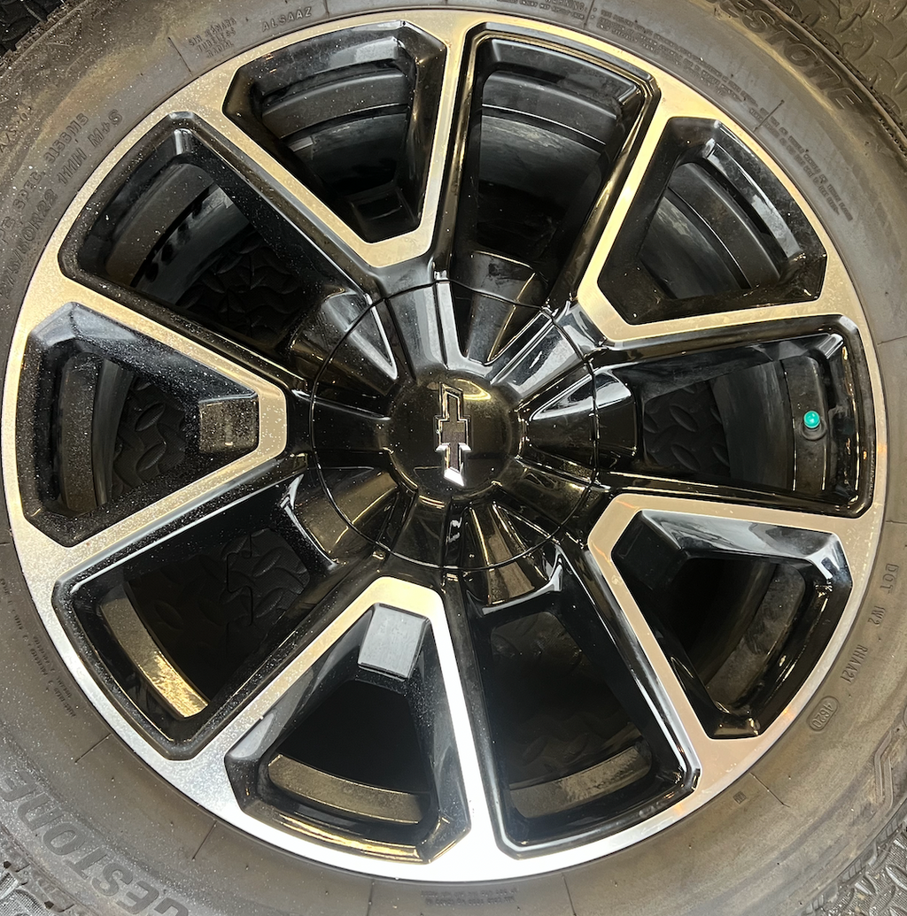 OEM 22” Black Machined Chevrolet Tahoe/Suburban Wheels wrapped in Bridgestone tires.