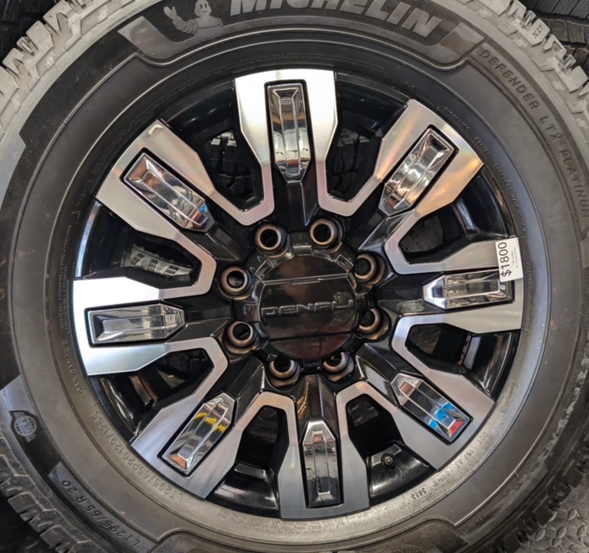 OEM 20” GMC Sierra Denali Ultimate Wheels with Machined & Black Finish wrapped in LT295/65R20 Michelin Defender LTX Platinum tires.