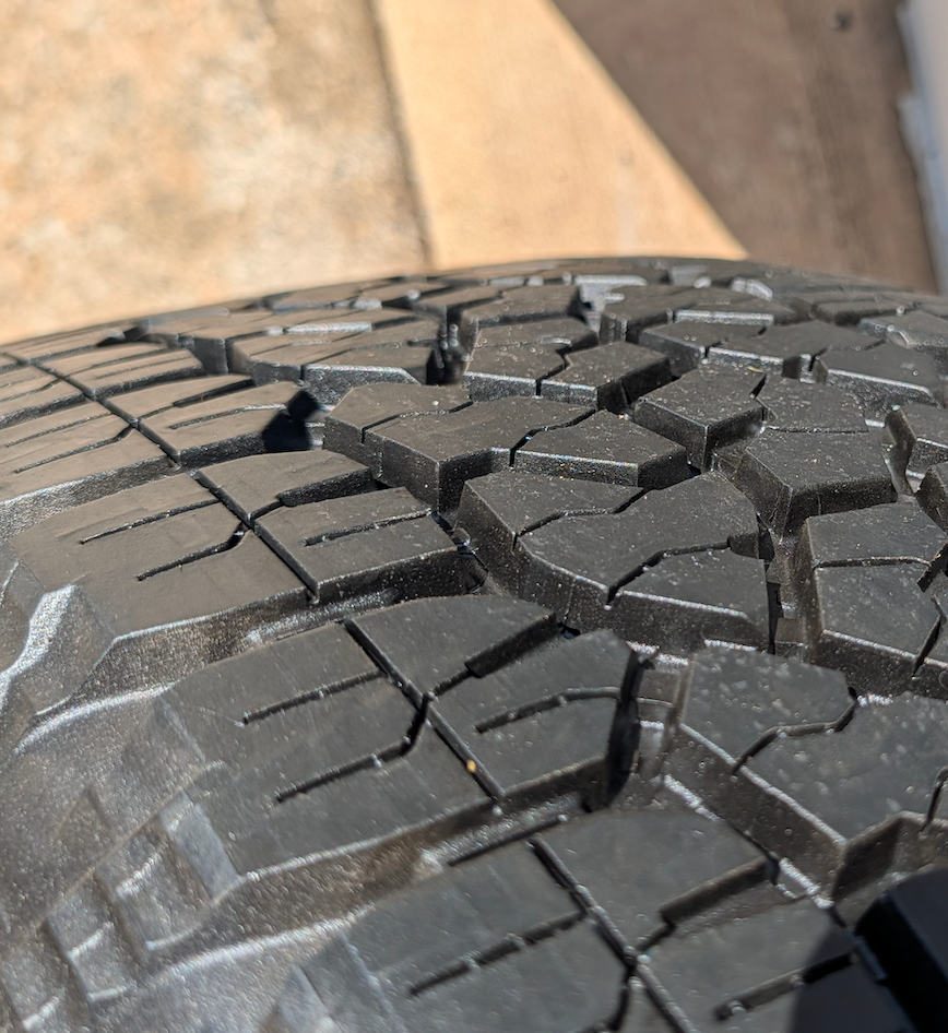OEM 20” GMC Sierra 2500HD / 3500HD AT4 Black Wheels wrapped in Goodyear Wrangler TrailRunner A/T tires.