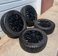 OEM 22” Gloss Black GMC HD Wheels with Split-Spoke Design wrapped in LT285/55R22 Falken Wildpeak A/T4W tires.