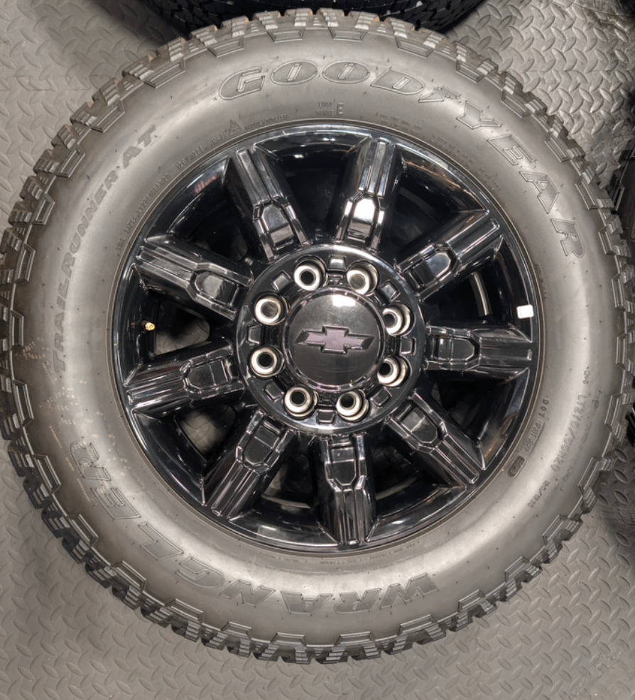 OEM 20” Gloss Black Chevrolet Silverado / GMC Sierra 2500HD & 3500HD Wheels wrapped in LT275/65R20 Goodyear Wrangler TrailRunner A/T tires.