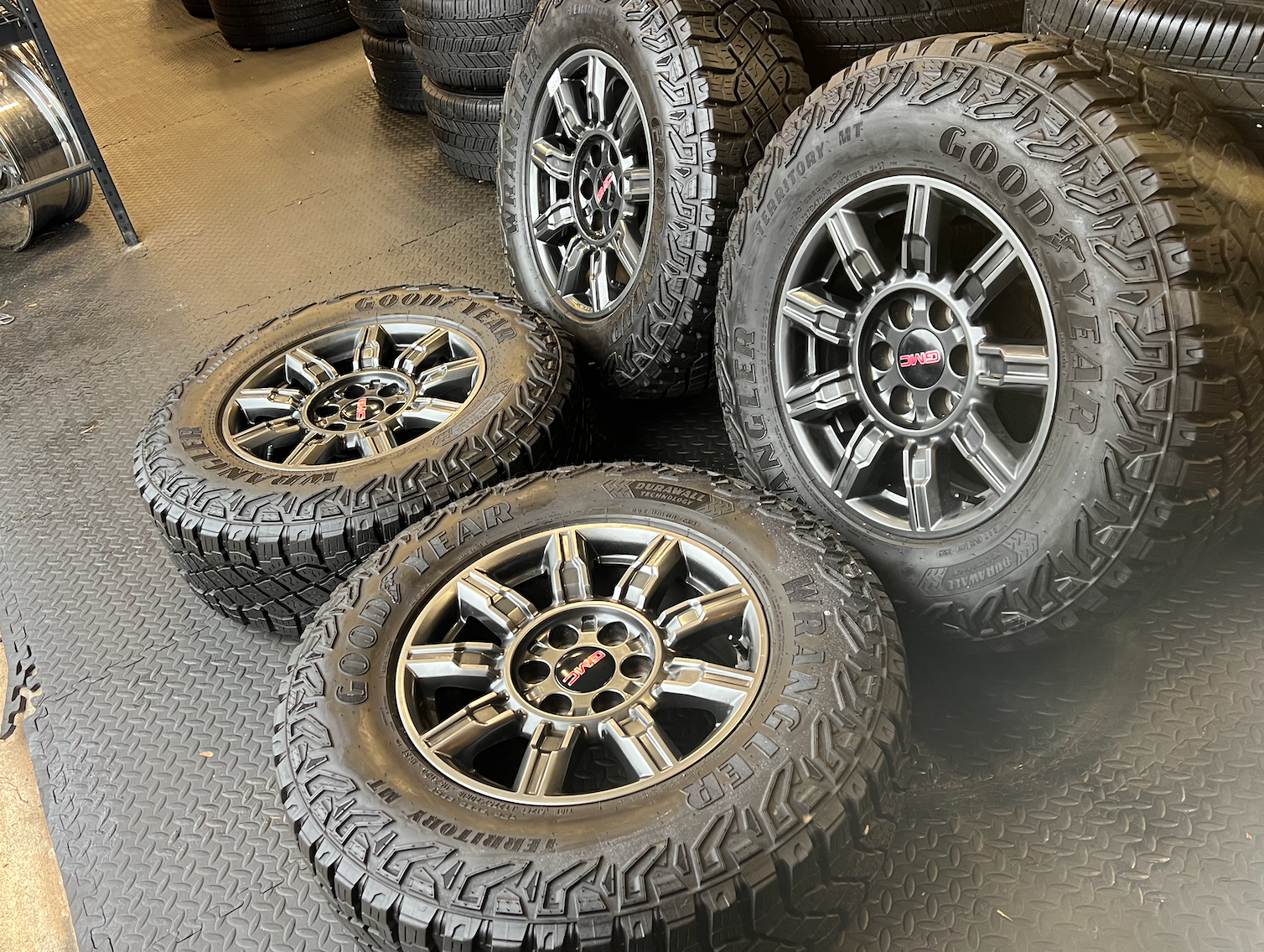 OEM 18" at4x machined aluminum Wheels wrapped in Goodyear tires.