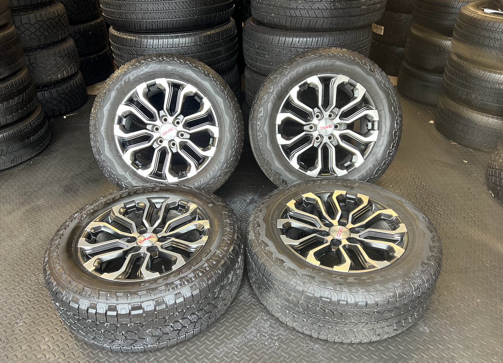 OEM 20” Charcoal Machined Wheels wrapped in Bridgestone Dueler A/T tires.