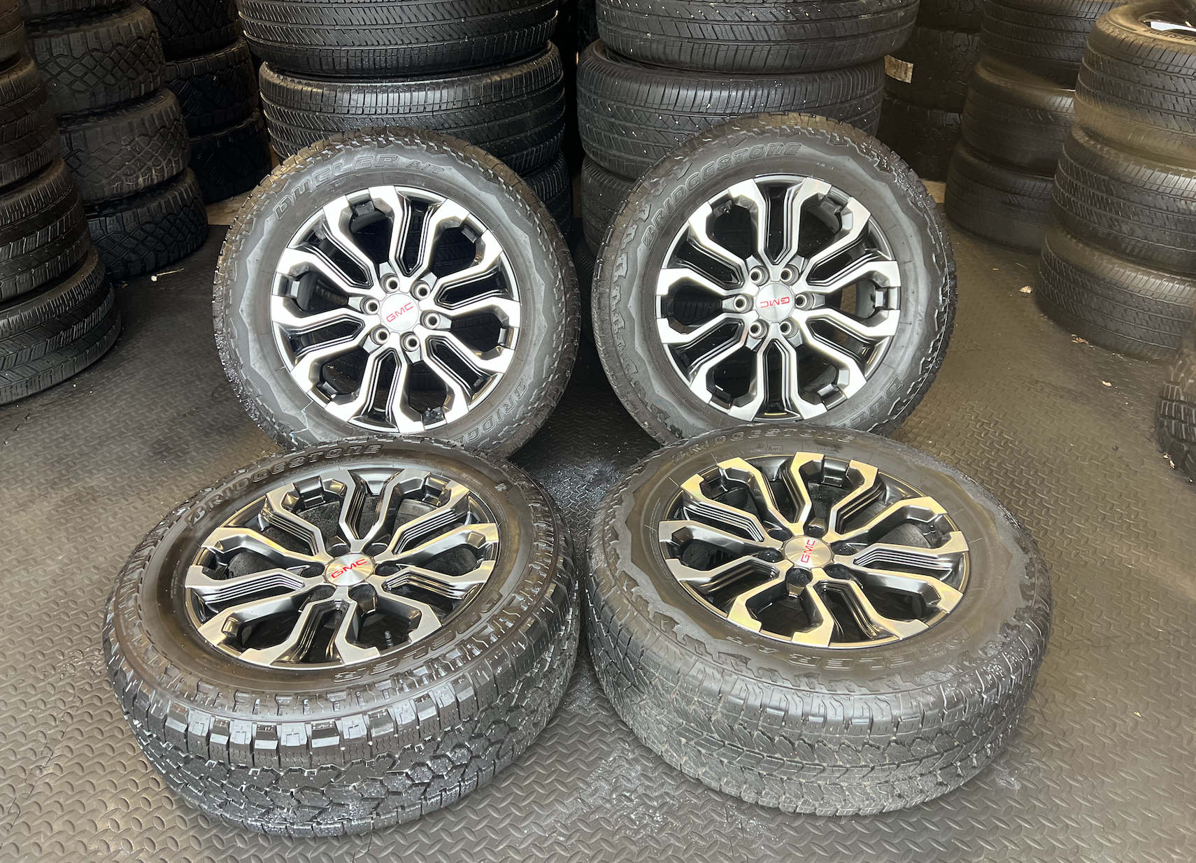 OEM 20” Charcoal Machined Wheels wrapped in Bridgestone Dueler A/T tires.