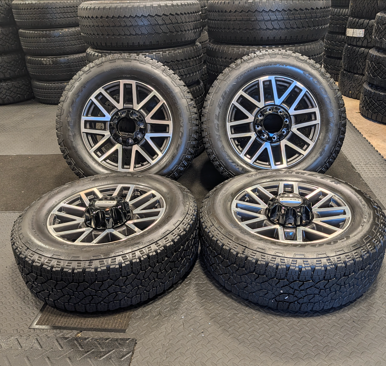 OEM 20” Machined Aluminum Ford F-250 / F-350 Super Duty Wheels wrapped in Goodyear Wrangler TrailRunner A/T tires.