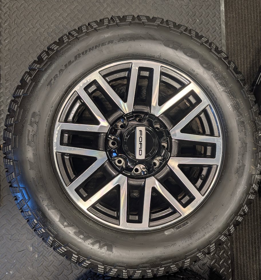 OEM 20” Machined Aluminum Ford F-250 / F-350 Super Duty Wheels wrapped in Goodyear Wrangler TrailRunner A/T tires.