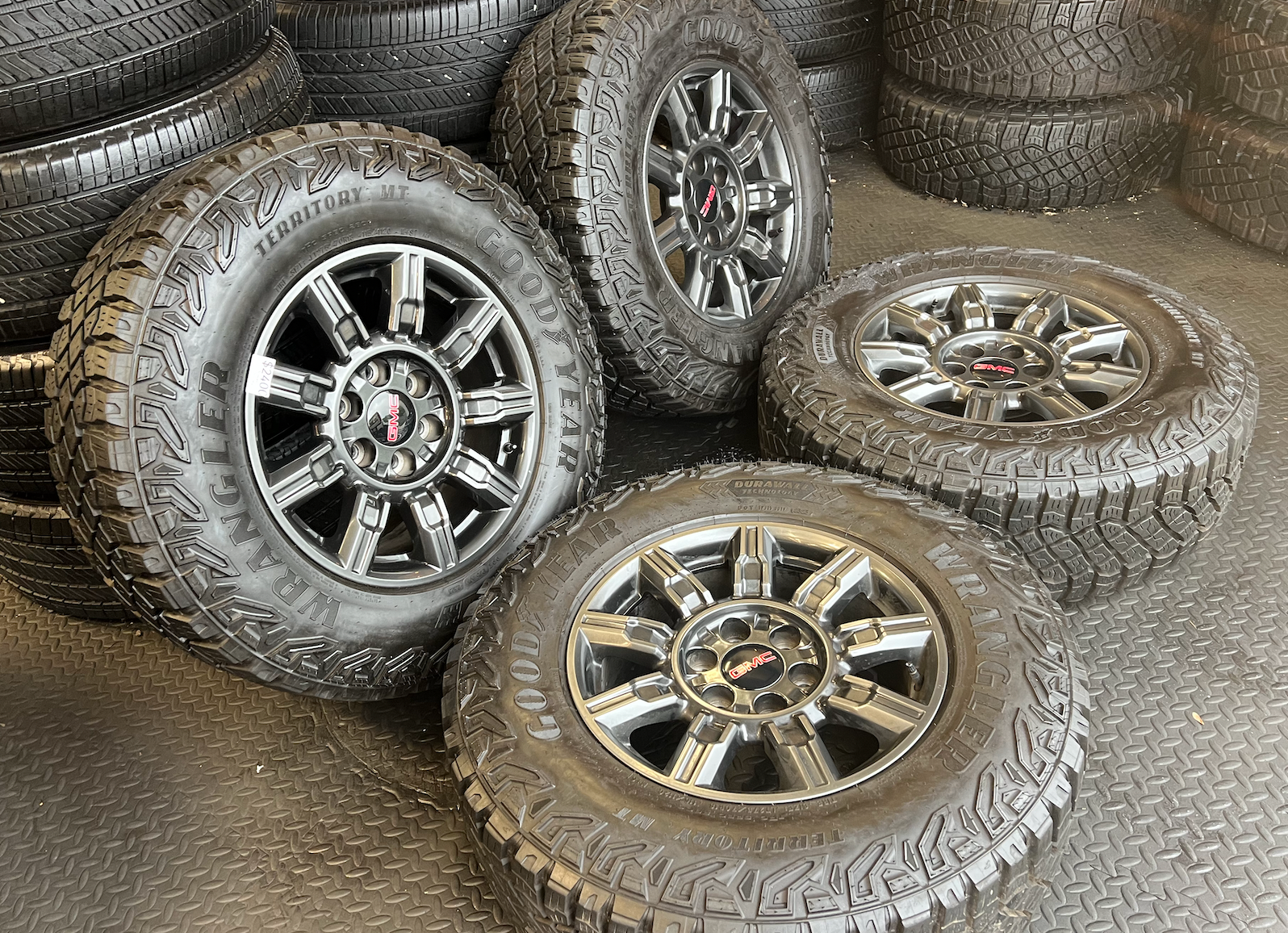 OEM 18" at4x machined aluminum Wheels wrapped in Goodyear tires.