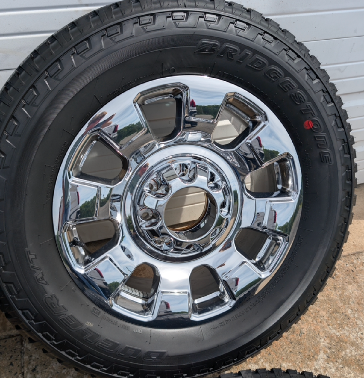 OEM 20” Chrome Ford F-250 / F-350 Wheels wrapped in Bridgestone Dueler A/T tires.