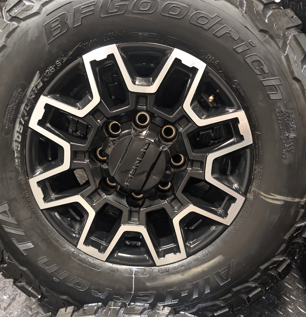 OEM 18” GMC Sierra 2500HD Wheels with Machined Black Finish wrapped in LT305/70R18 BFGoodrich All-Terrain T/A KO3 tires.