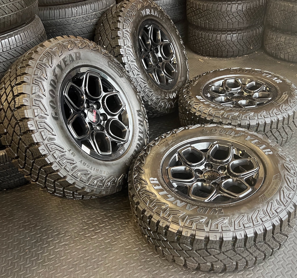 Gloss Black GMC Sierra 1500 AT4X OEM 18” Wrapped in Goodyear Wrangler Territory M/T LT275/70R18