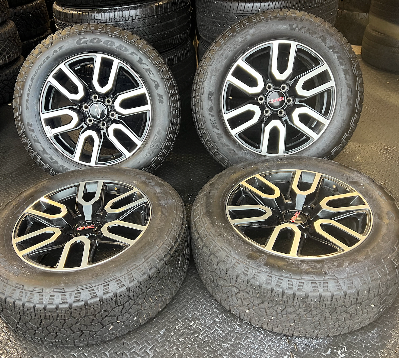 OEM 20” Gloss Black Wheels with Silver Inserts / Accents wrapped in Goodyear Wrangler TrailRunner A/T tires.