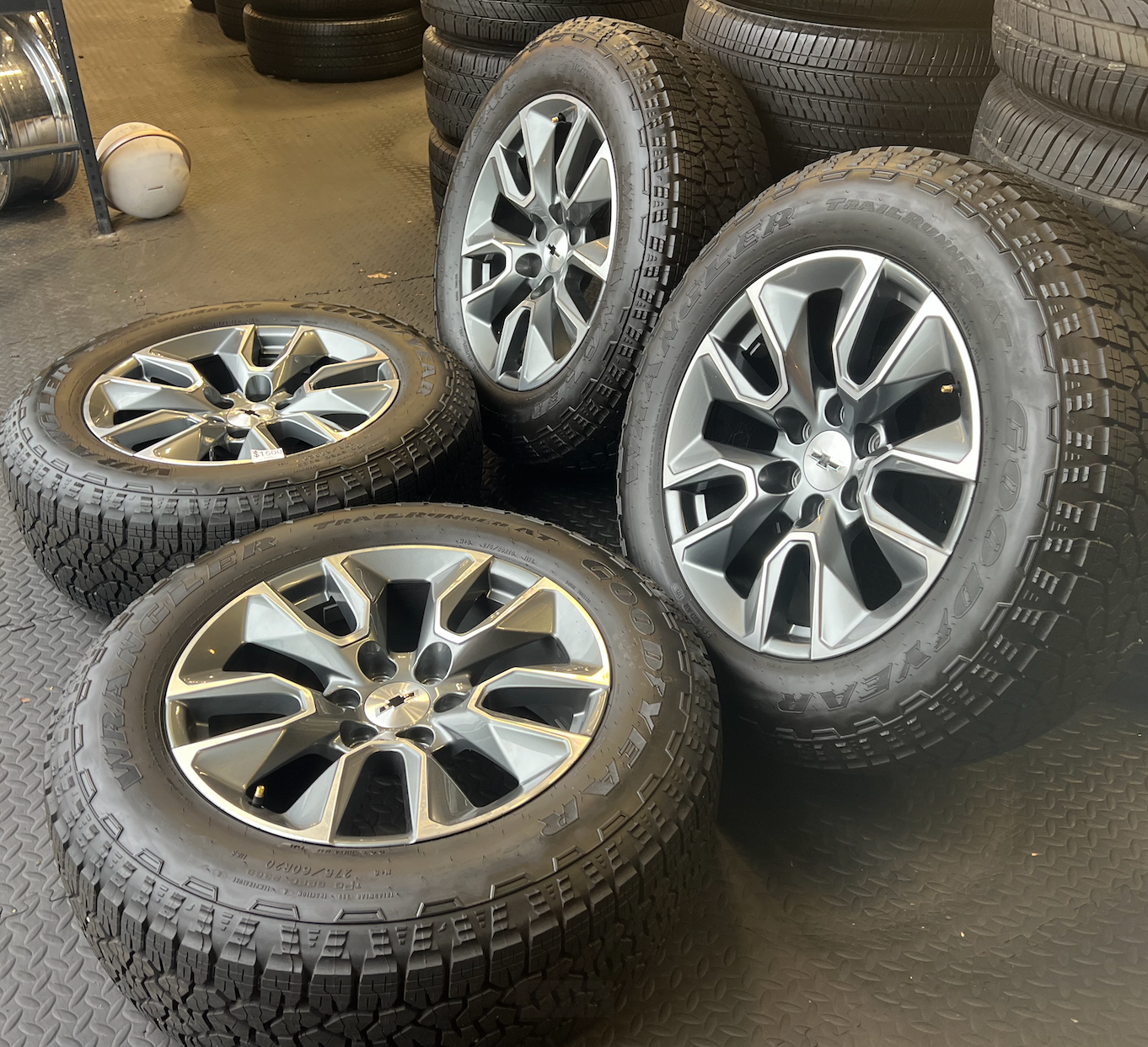 OEM 20”  Gunmetal & Machined Wheels wrapped in Goodyear Wrangler TrailRunner A/T tires.