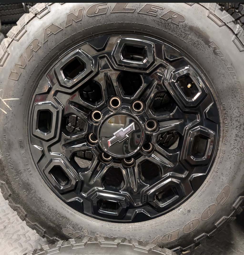 OEM 20” Gloss Black Chevrolet Silverado / GMC Sierra 2500HD & 3500HD Wheels wrapped in LT275/65R20 Goodyear Wrangler TrailRunner A/T tires.
