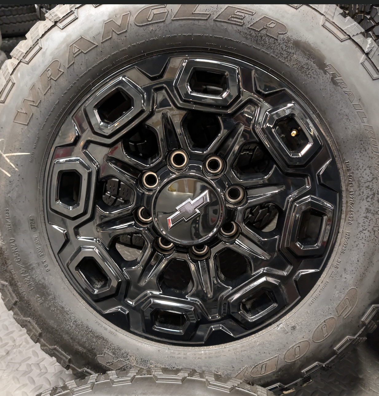 OEM 20” Gloss Black Chevrolet Silverado / GMC Sierra 2500HD & 3500HD Wheels wrapped in LT275/65R20 Goodyear Wrangler TrailRunner A/T tires.