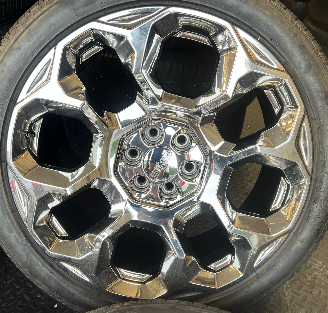 OEM 24” Chrome GMC Wheels wrapped in Bridgestone tires.