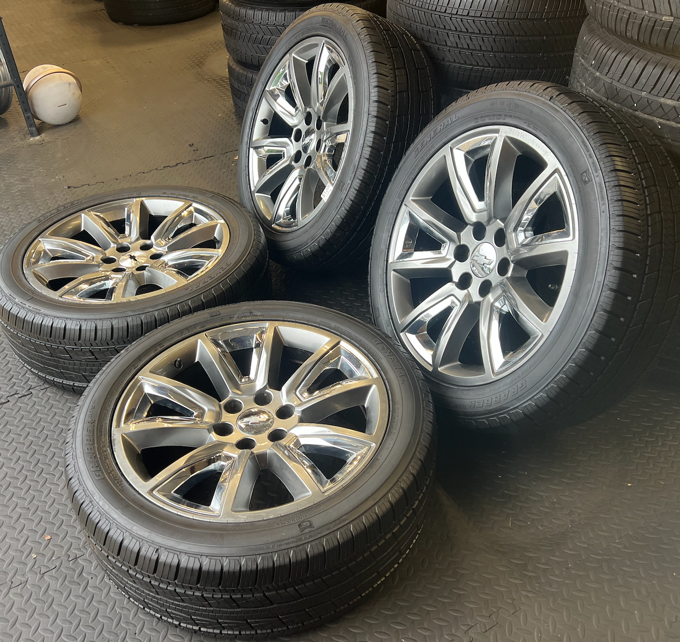 OEM 22” Wheels with Hypersilver Finish & Chrome Inserts wrapped in General Grabber tires.