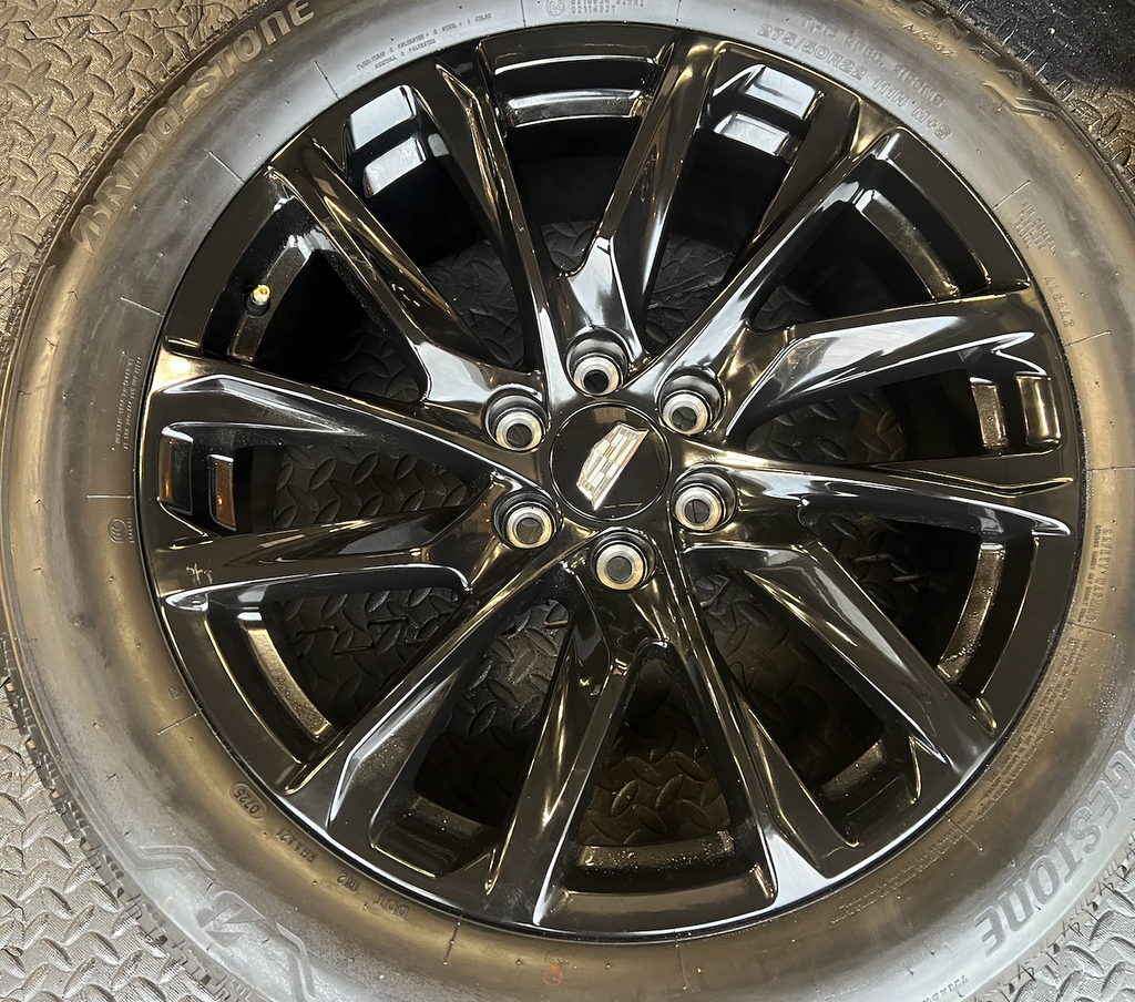 OEM 22” Gloss Black Wheels wrapped in Bridgestone tires.