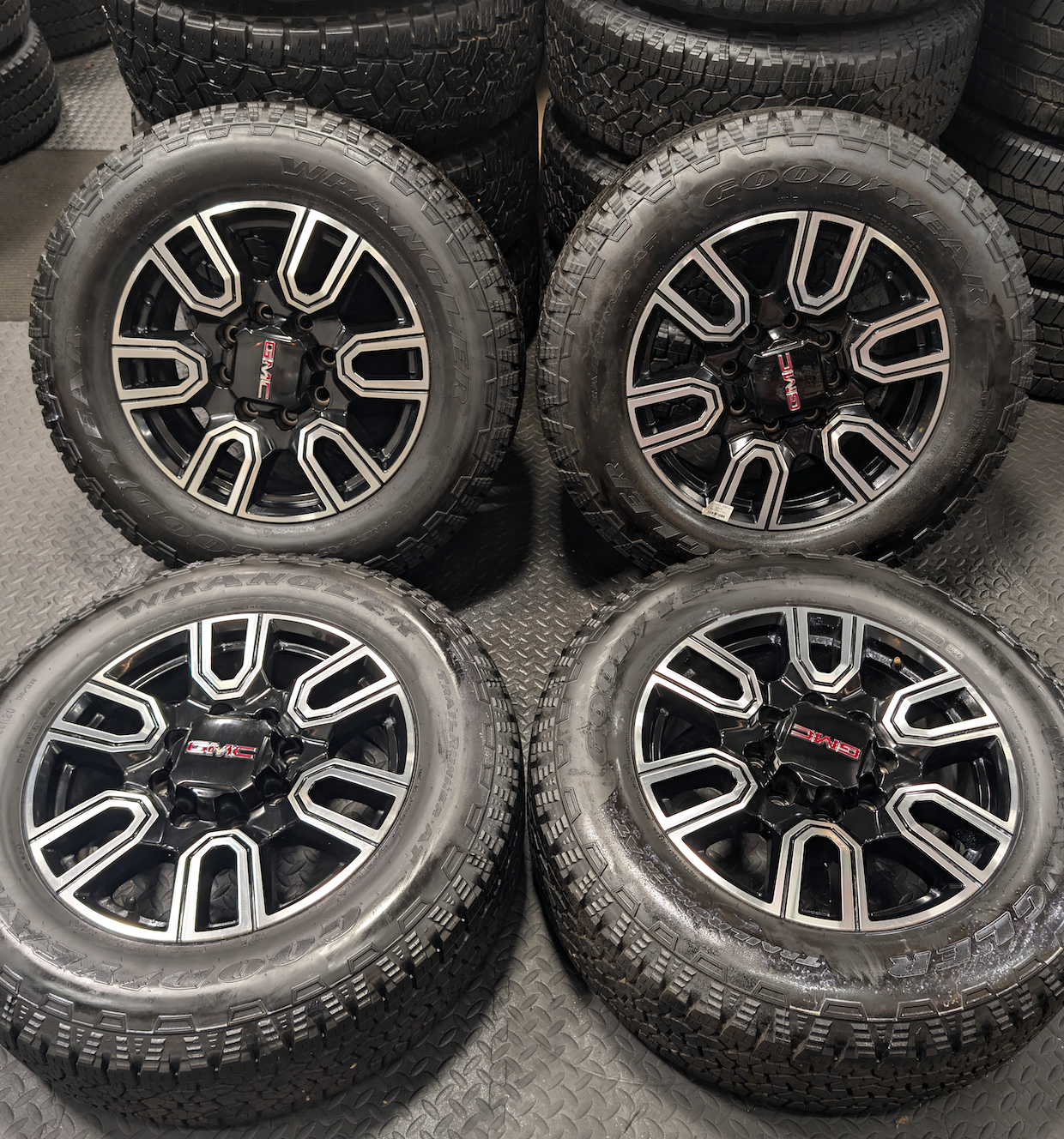 OEM 20” GMC Sierra AT4 2500HD / 3500HD Wheels with Black & Machined Finish wrapped in LT275/65R20 Goodyear Wrangler TrailRunner A/T tires.
