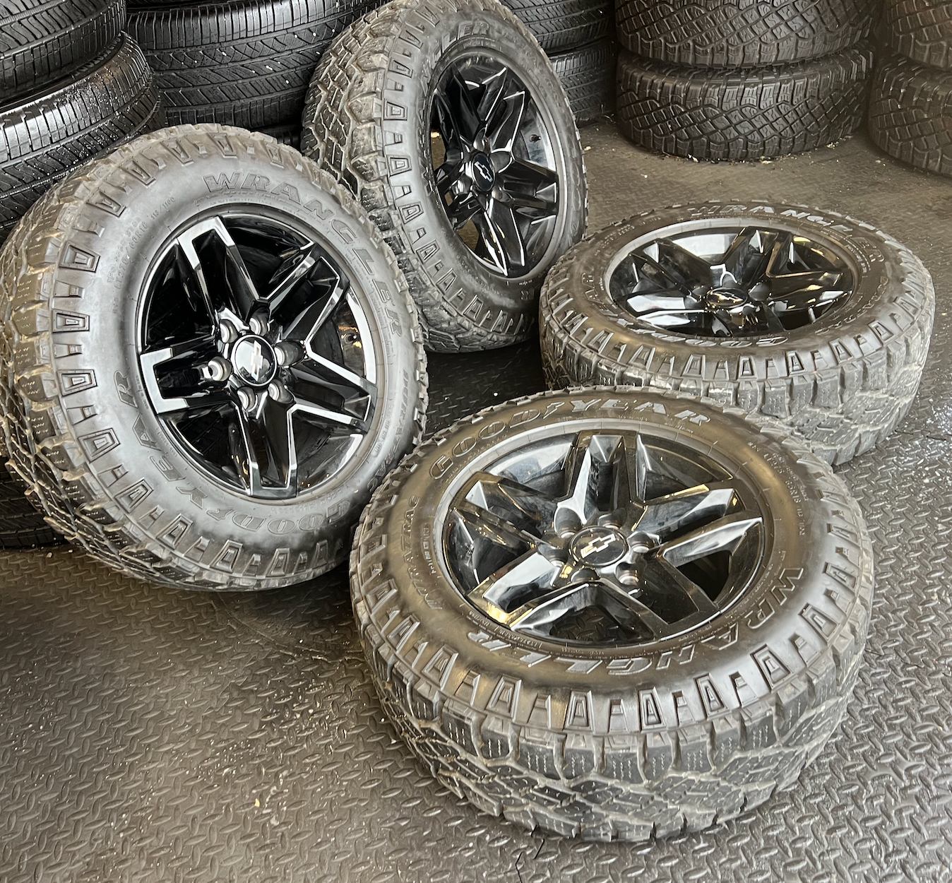 OEM 18” Gloss Black Trail Boss Wheels wrapped in Goodyear Wrangler Duratrac tires.