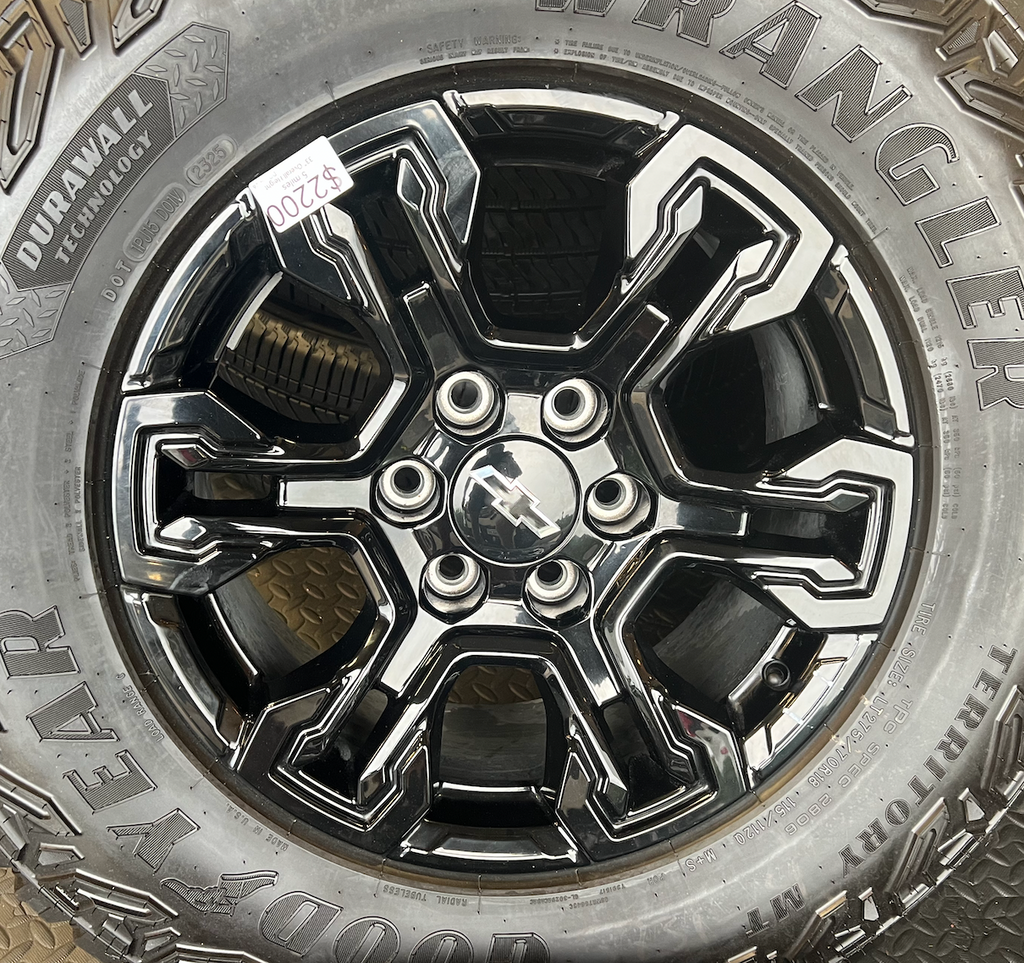 OEM 18” Gloss Black Chevrolet Silverado ZR2 Wheels wrapped in LT275/70R18 Goodyear Wrangler Territory MT tires.