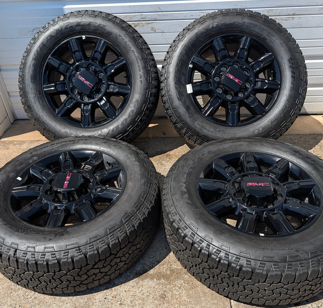 OEM 20” GMC Sierra 2500HD / 3500HD AT4 Black Wheels wrapped in Goodyear Wrangler TrailRunner A/T tires.