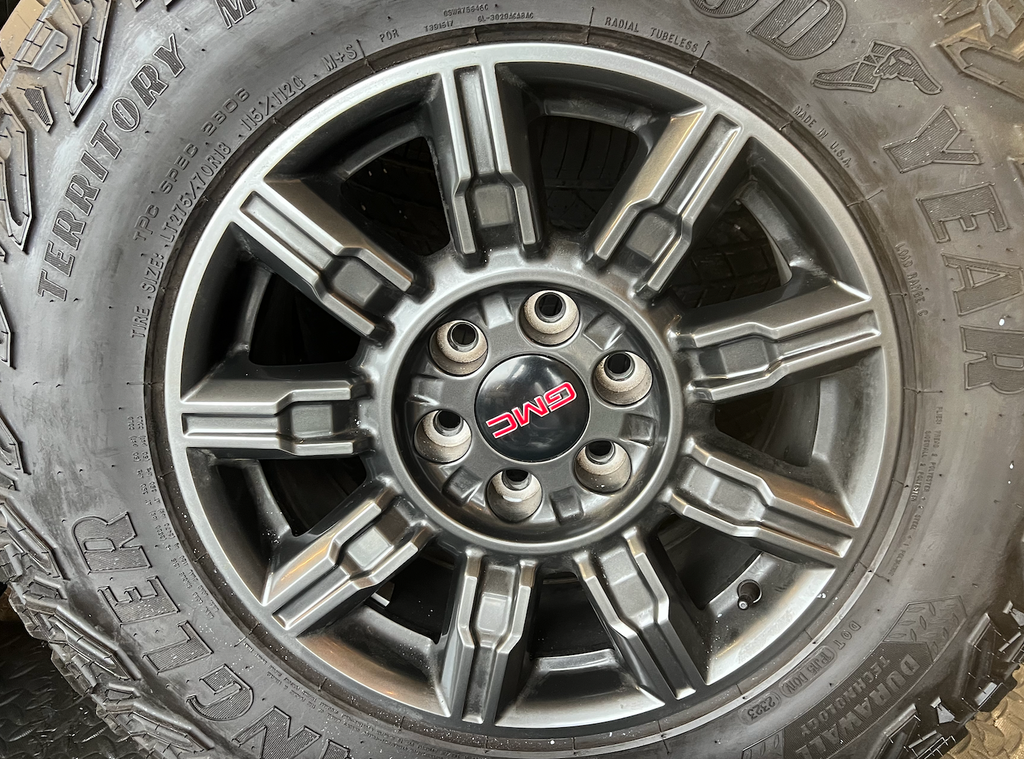 OEM 18" at4x machined aluminum Wheels wrapped in Goodyear tires.