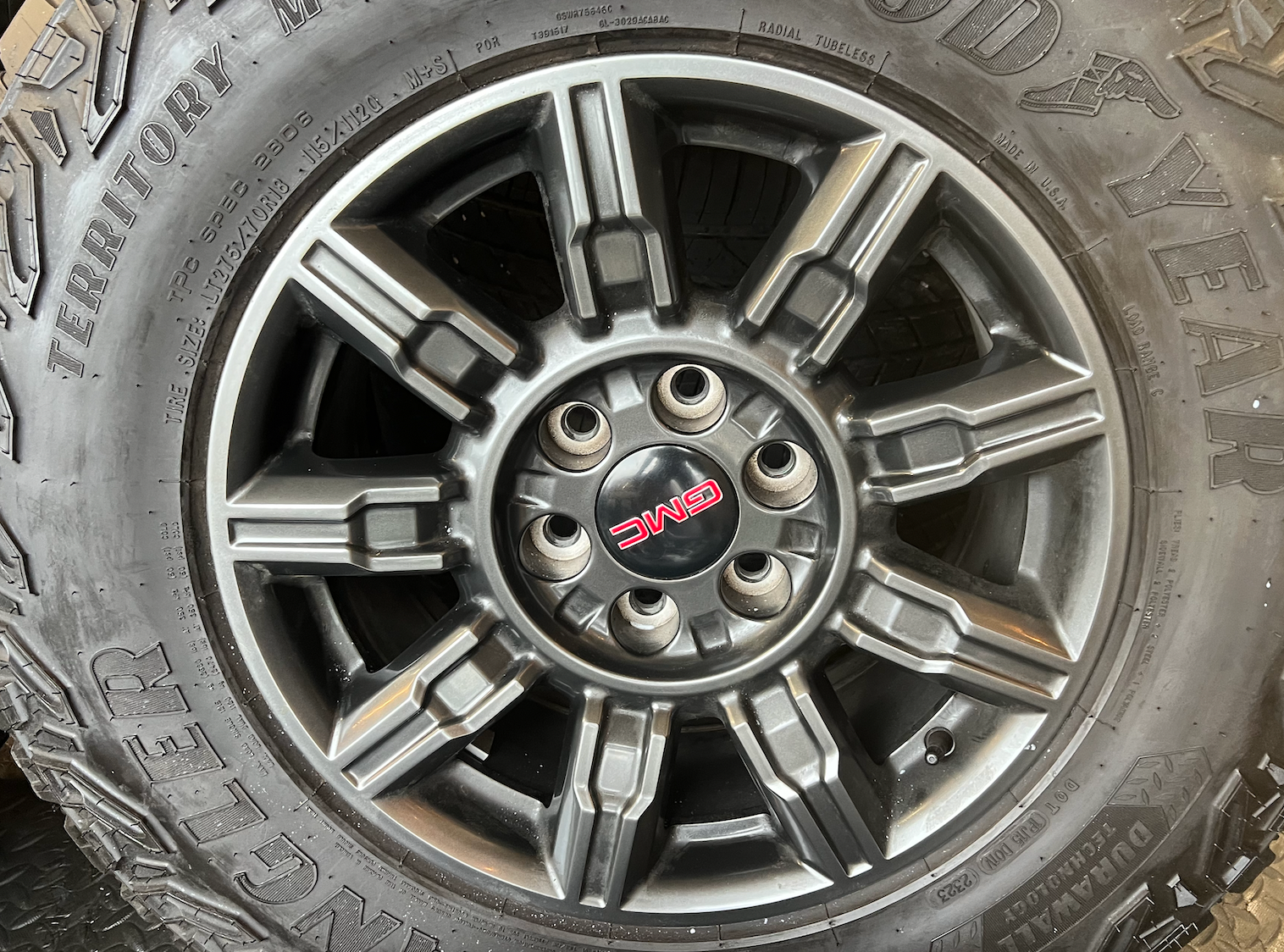 OEM 18" at4x machined aluminum Wheels wrapped in Goodyear tires.