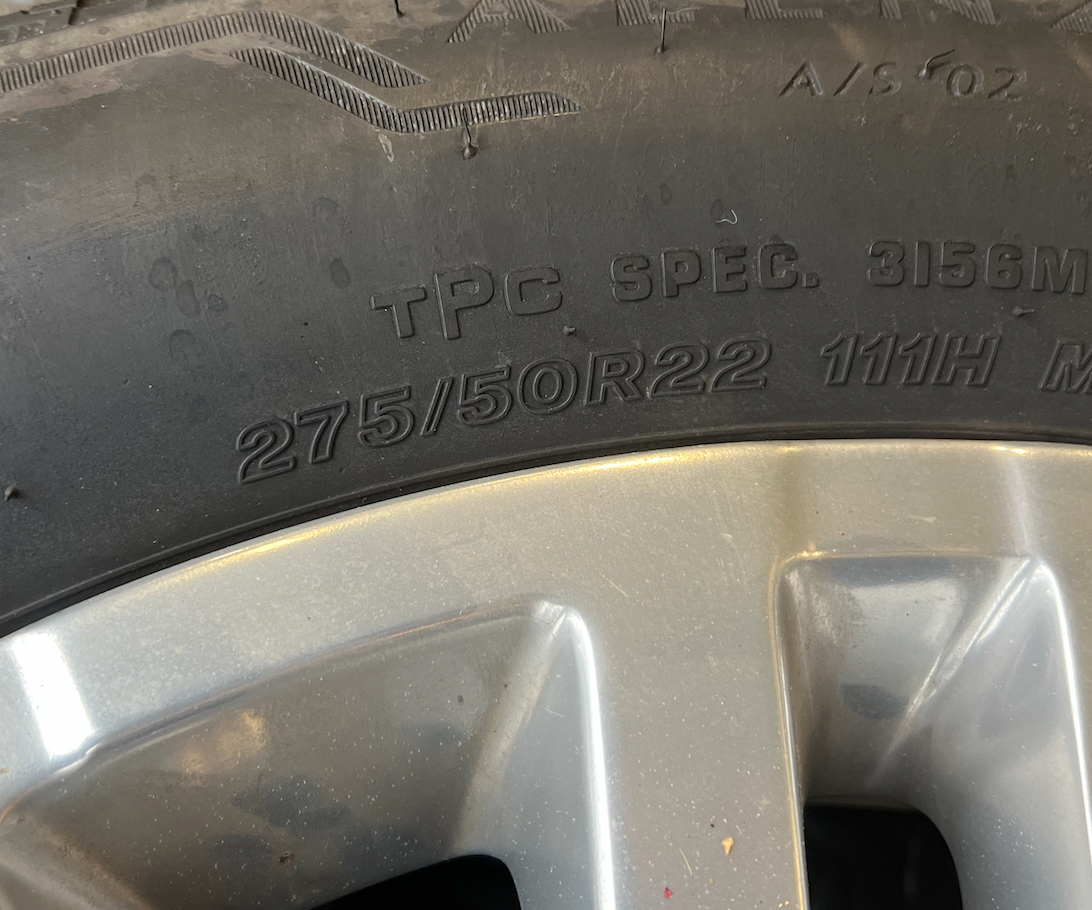 OEM 22” Polished 6-Split-Spoke Chevrolet Wheels wrapped in Bridgestone tires.