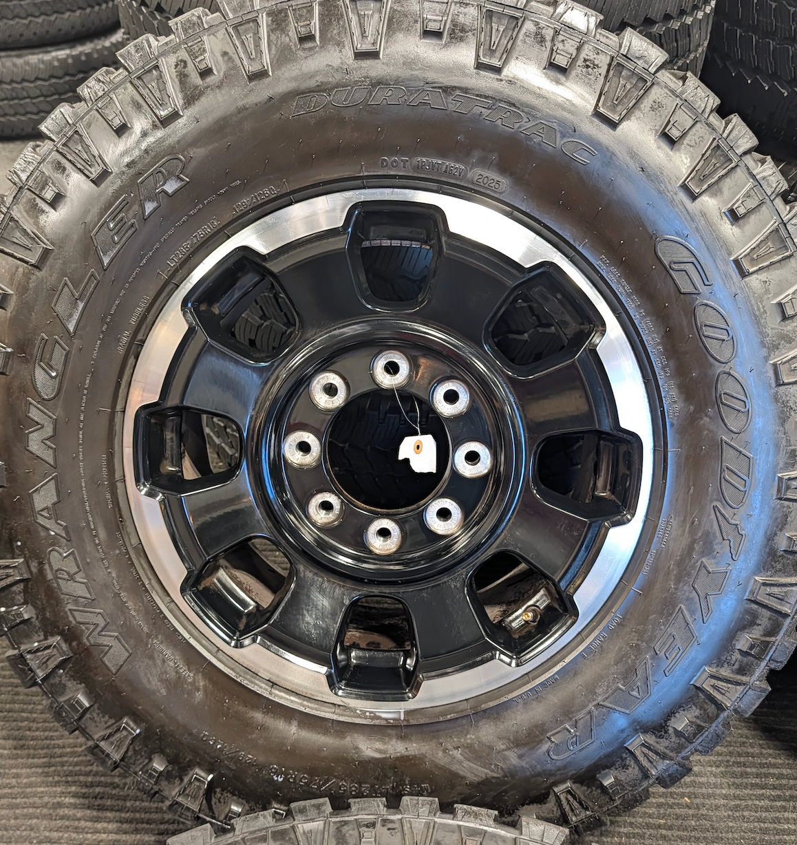 OEM 18” Gloss Black Machined Ford F-250 / F-350 Tremor Wheels wrapped in LT285/75R18 Goodyear Wrangler DuraTrac tires.