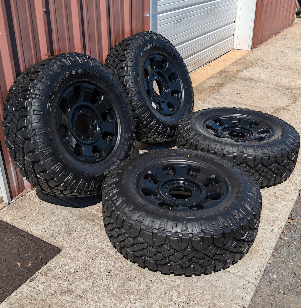 OEM 18” Ford F-250 / F-350 Tremor Wheels with Matte Black Finish wrapped in Goodyear Wrangler Duratrac tires.