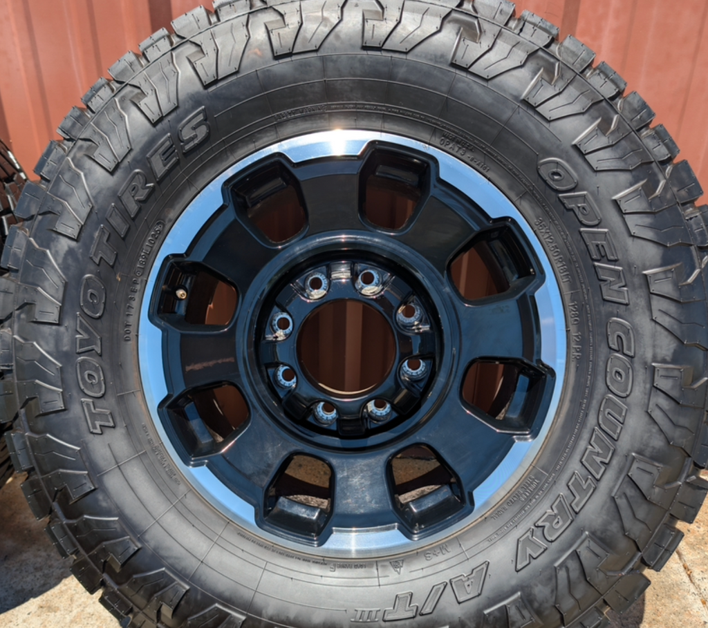 Machined Ford F-250 / F-350 Tremor OEM 18” Wrapped in Toyo Open Country A/T 35x12.50R18LT 128Q