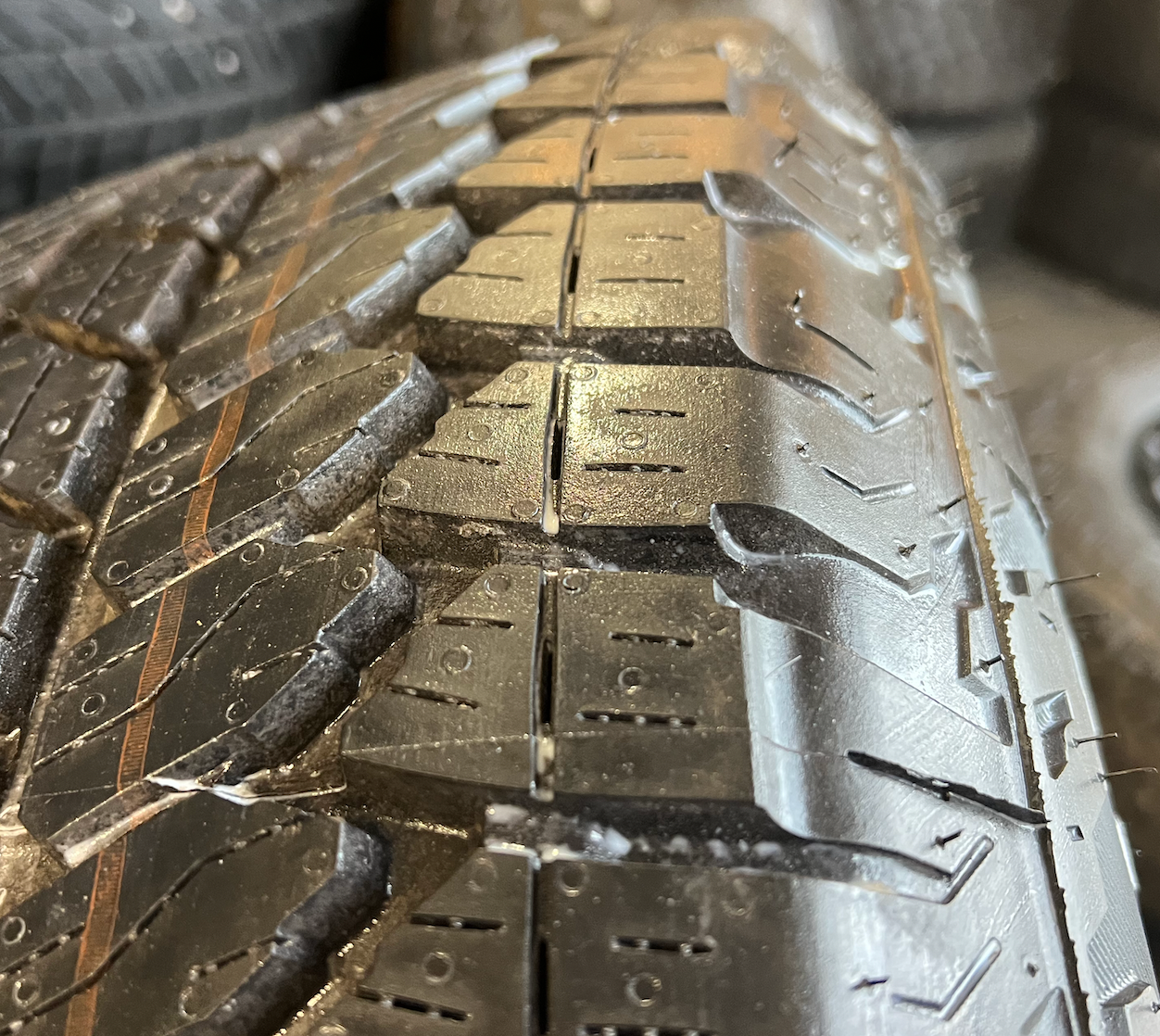 OEM 20” Gloss Black Wheels wrapped in Bridgestone Dueler A/T tires.
