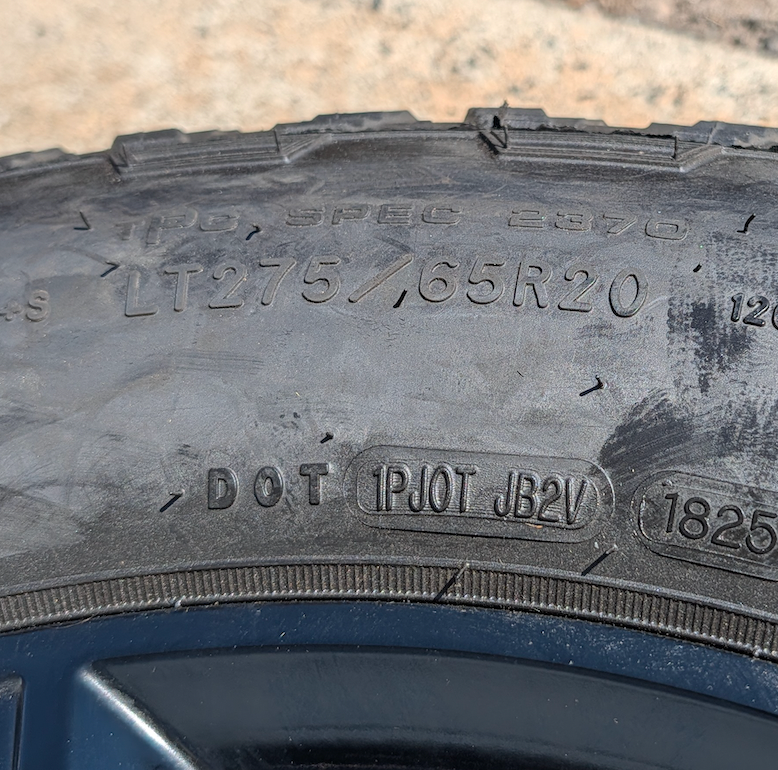 OEM 20” GMC Sierra 2500HD / 3500HD AT4 Black Wheels wrapped in Goodyear Wrangler TrailRunner A/T tires.