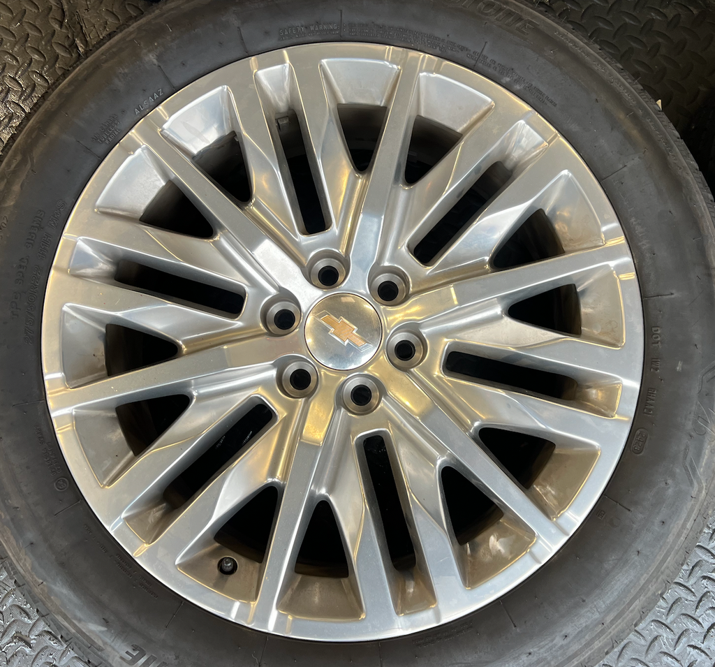 OEM 22” Polished 6-Split-Spoke Chevrolet Wheels wrapped in Bridgestone tires.