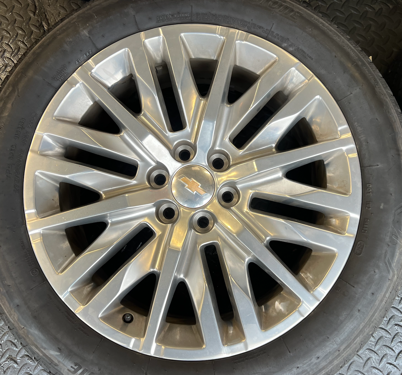 OEM 22” Polished 6-Split-Spoke Chevrolet Wheels wrapped in Bridgestone tires.