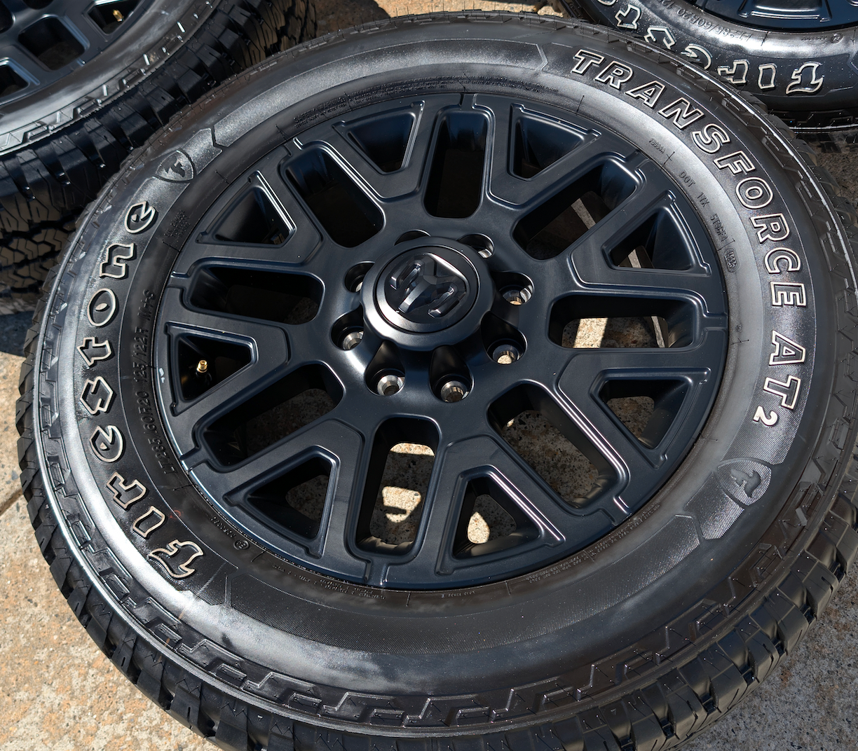 OEM 20” Matte Black Dodge RAM 2500 / 3500 Wheels wrapped in LT285/60R20 Firestone Transforce AT2 tires.
