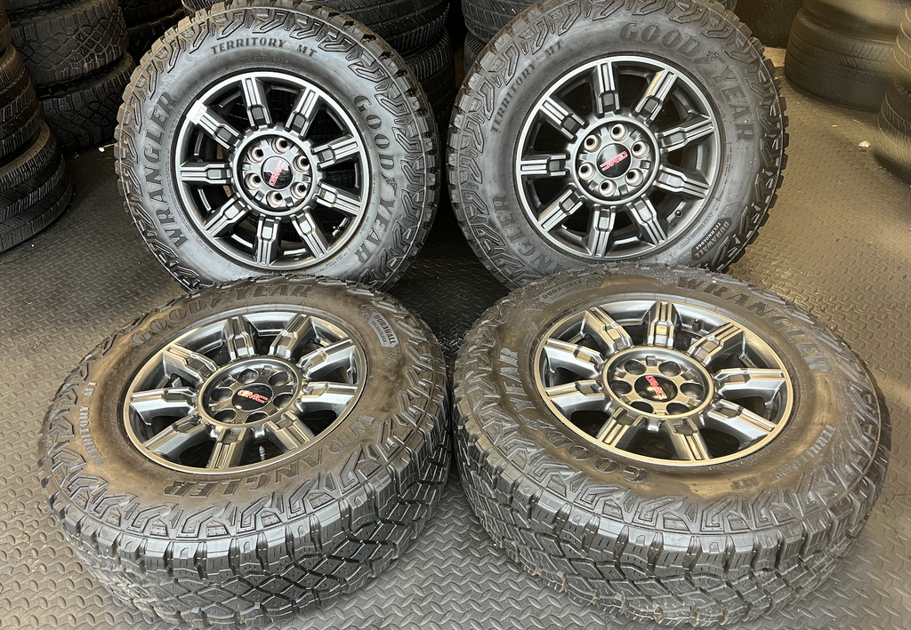 OEM 18" at4x machined aluminum Wheels wrapped in Goodyear tires.