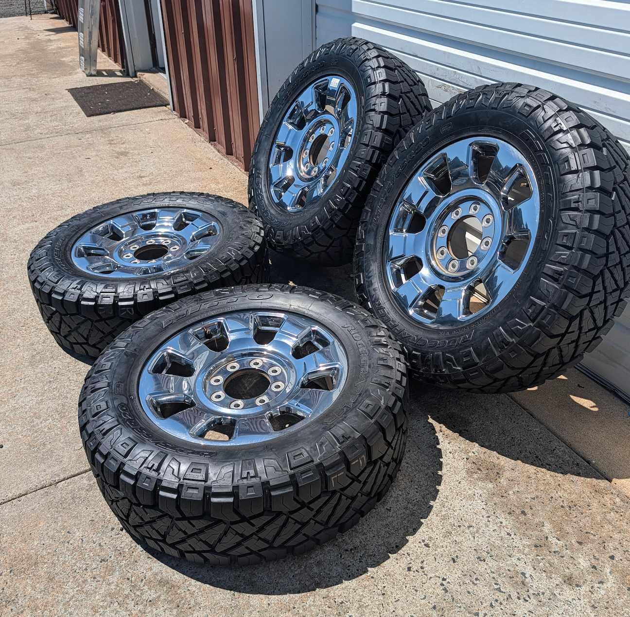 OEM 20” Chrome Ford F-250 / F-350 King Ranch / Lariat Wheels wrapped in LT275/65R20 Nitto Ridge Grappler tires.