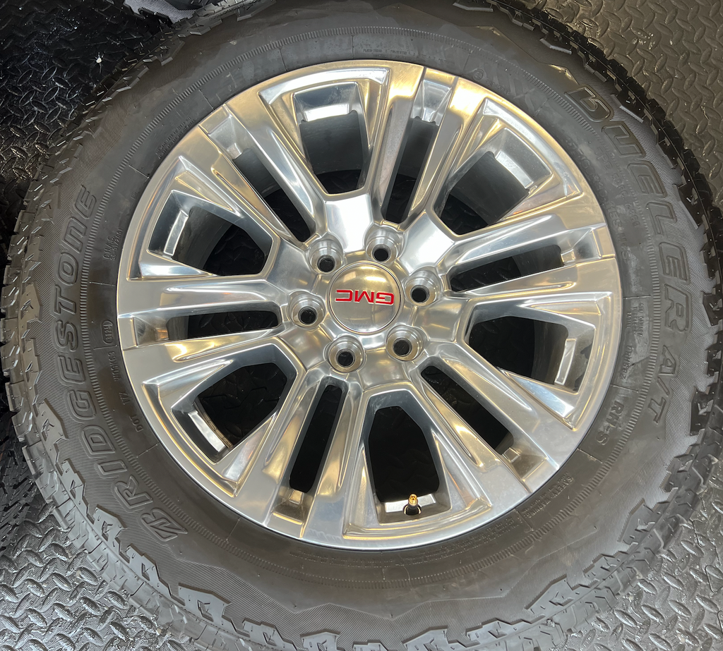 OEM Rebuilt 20” Polished Wheels wrapped in Bridgestone Dueler tires.