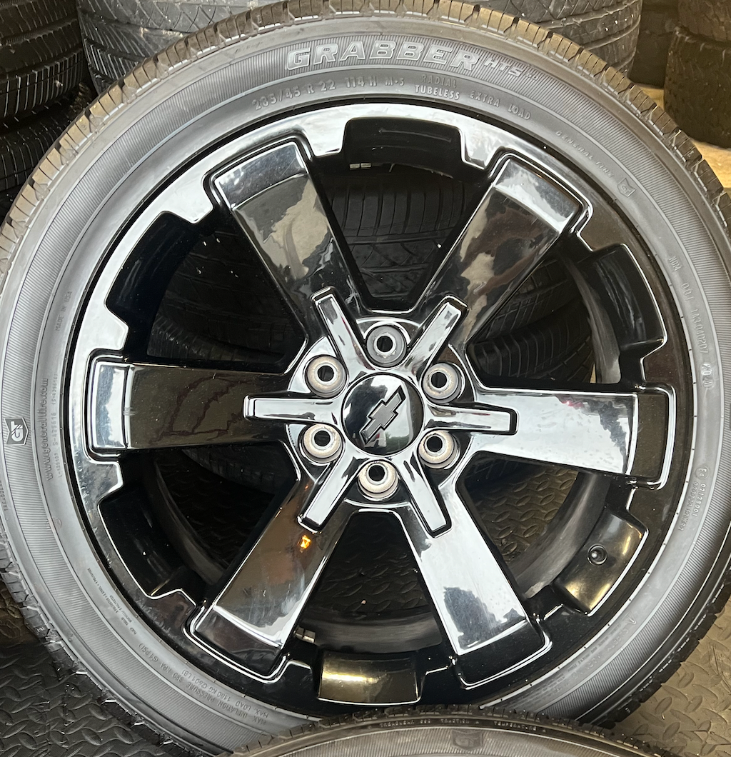 OEM 22” Gloss Black Wheels wrapped in General Grabber tires.