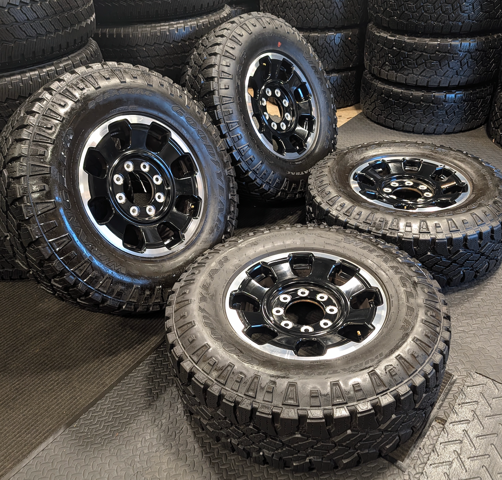 OEM 18” Gloss Black Machined Ford F-250 / F-350 Tremor Wheels wrapped in LT285/75R18 Goodyear Wrangler DuraTrac tires.