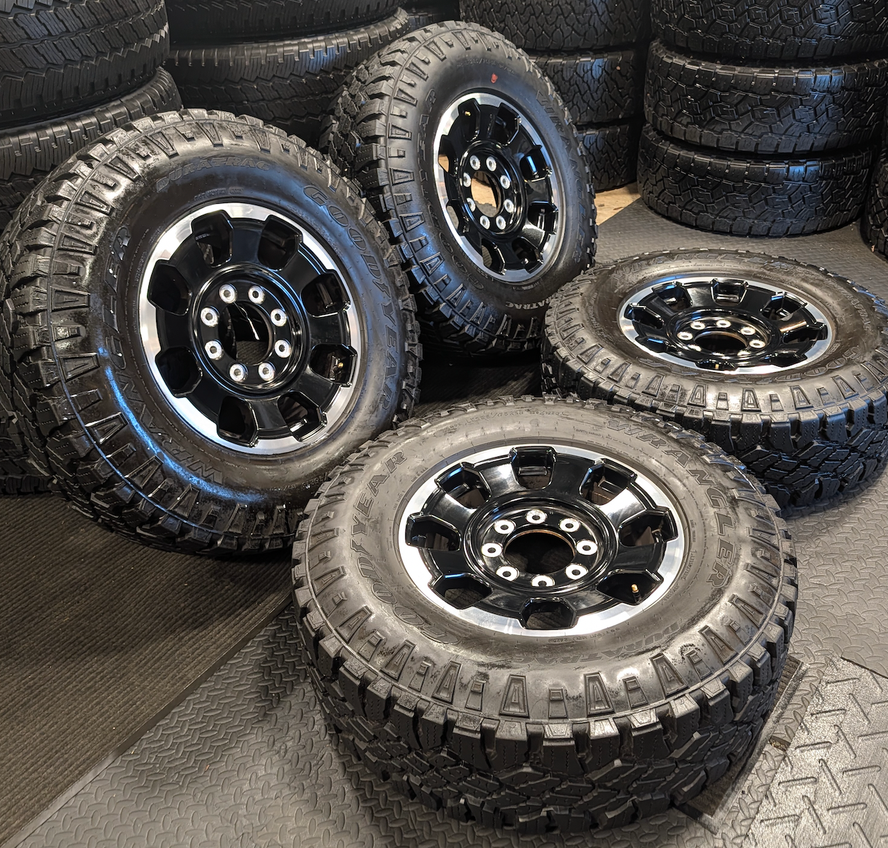 OEM 18” Gloss Black Machined Ford F-250 / F-350 Tremor Wheels wrapped in LT285/75R18 Goodyear Wrangler DuraTrac tires.