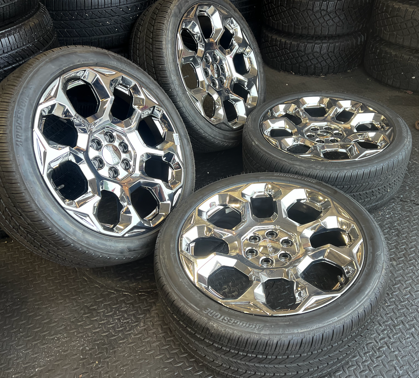 OEM 24” Chrome GMC Wheels wrapped in Bridgestone tires.