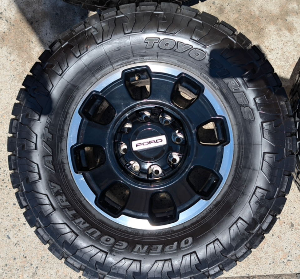 Machined Ford F-250 / F-350 Tremor OEM 18” Wrapped in Toyo Open Country A/T 35x12.50R18LT 128Q