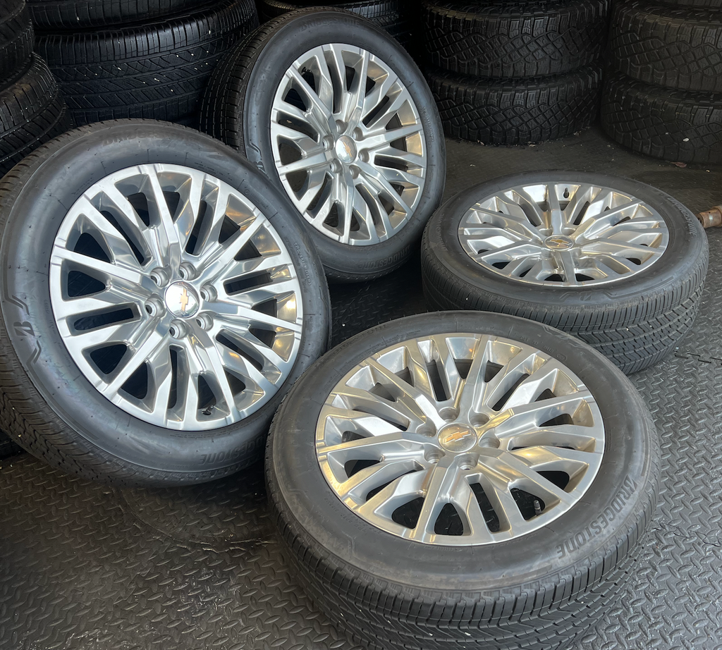 OEM 22” Polished 6-Split-Spoke Chevrolet Wheels wrapped in Bridgestone tires.