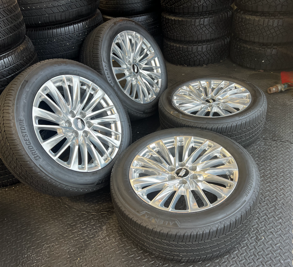 OEM 22” Polished Aluminum Wheels wrapped in Bridgestone tires.