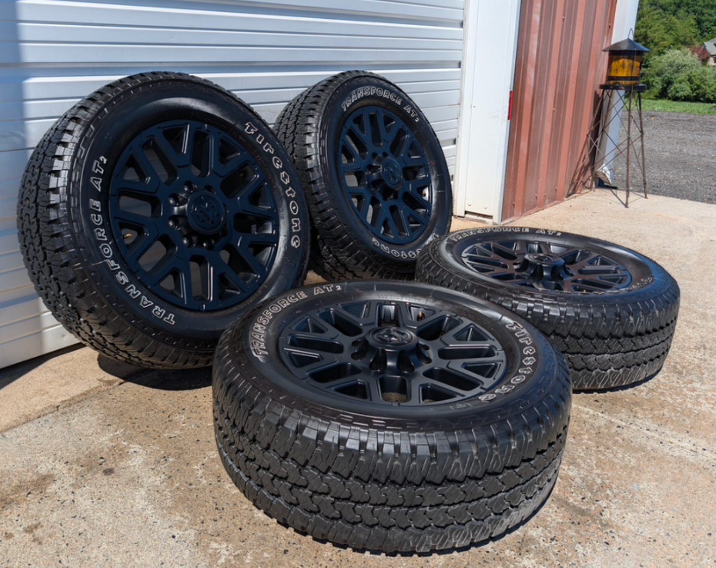 OEM 20” Matte Black Dodge RAM 2500 / 3500 Wheels wrapped in LT285/60R20 Firestone Transforce AT2 tires.