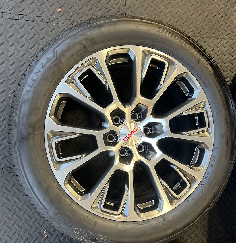 OEM 22” Machined Silver Denali Wheels wrapped in Bridgestone tires.